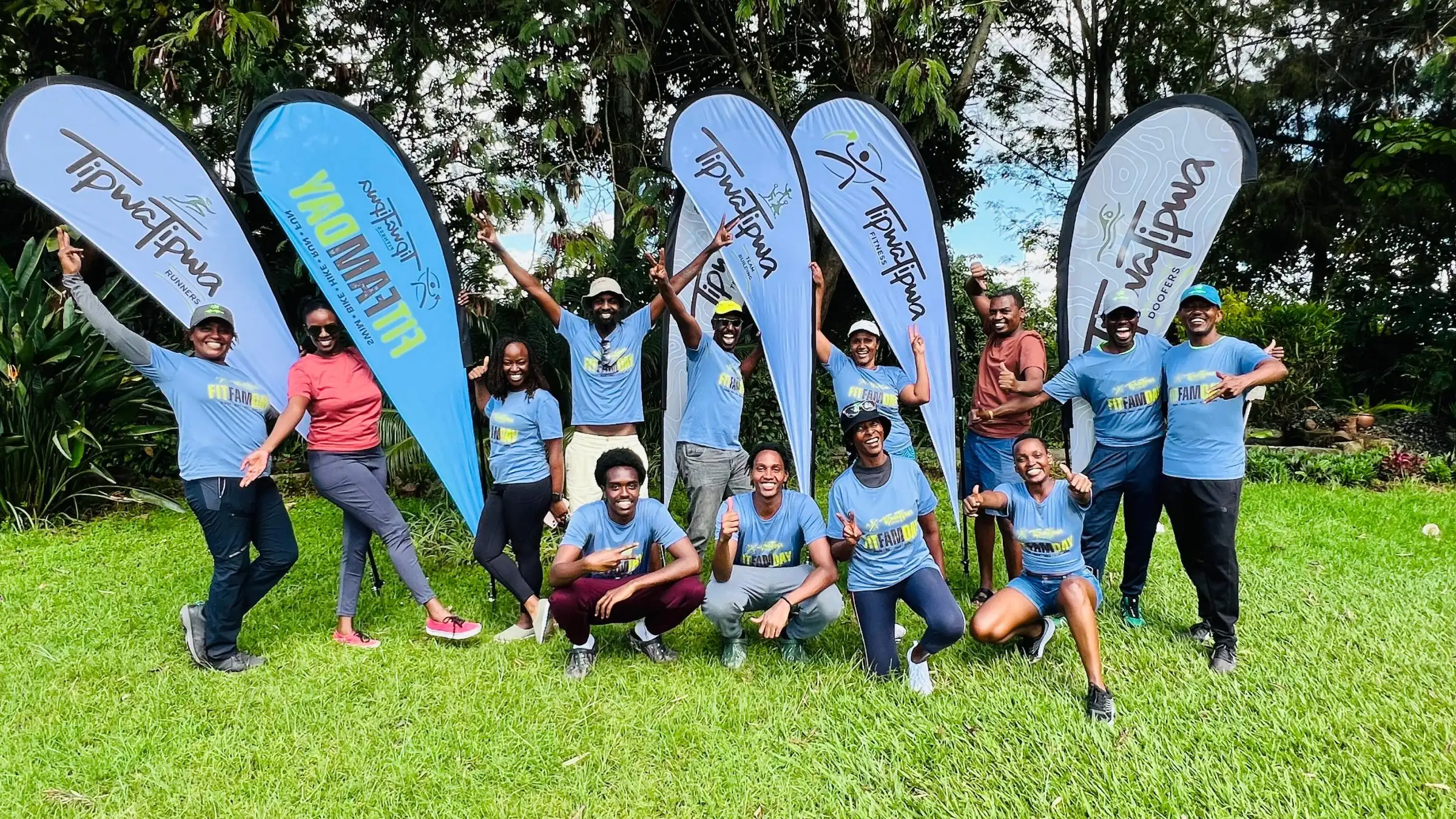 TipwaTipwa members together under branded flags at a community fitness day