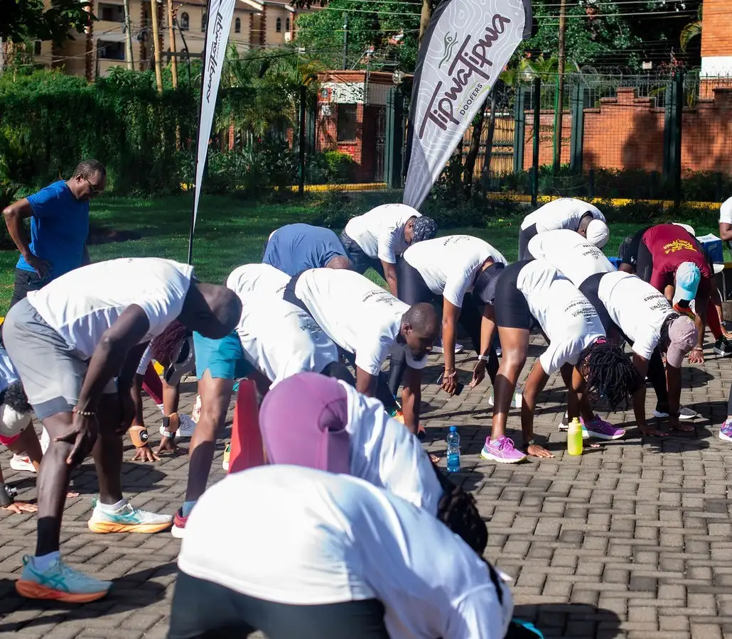 TipwaTipwa members warming up together before a run, club flags behind them